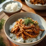 Crock Pot Teriyaki Chicken dish served with steamed rice and vegetables.