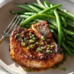 Plate of delicious Honey Garlic Pork Chops garnished with herbs