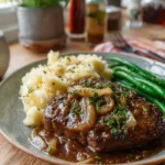 Delicious cube steak with onion gravy served on a plate