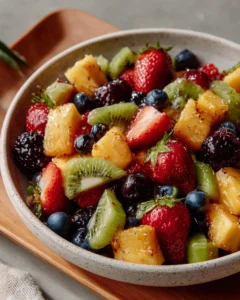 Colorful fruit salad topped with honey lime dressing