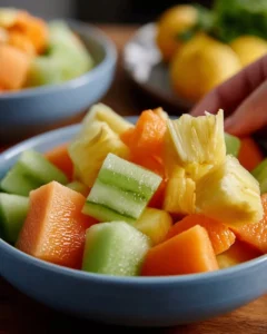 A colorful Mango Melon Salad with fresh ingredients and vibrant colors