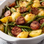 Delicious Sausage Potato Green Bean Casserole in a baking dish