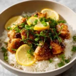 Delicious lemon chicken served with vibrant vegetables in Chinese style.