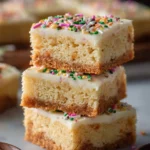 Delicious soft sugar cookie bars topped with colorful frosting.