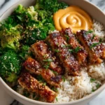 Delicious Sticky Chicken Rice Bowls topped with herbs and vegetables