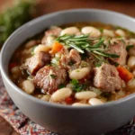 Bowl of delicious Amish Bean Soup garnished with herbs