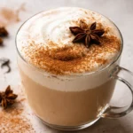 A cozy chai latte topped with cinnamon and served in a warm mug