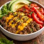 High-protein cheeseburger bowls with fresh ingredients in a bowl