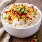 Delicious loaded baked potato soup topped with cheese, bacon, and chives