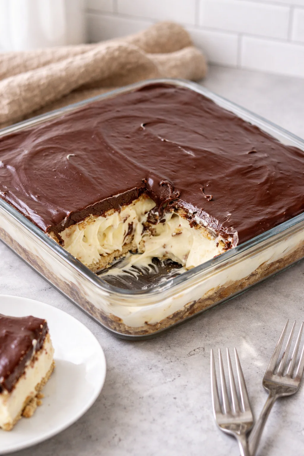 No bake chocolate eclair cake with layers of cream and chocolate frosting