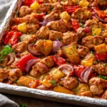 Sheet Pan Hawaiian Chicken served with colorful vegetables and pineapple.