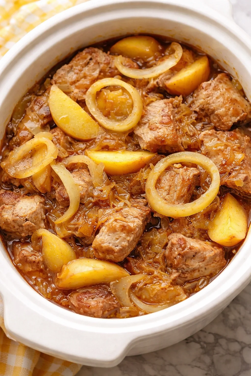 Slow Cooker Pork Loin with Sauerkraut and Apples dish garnished and ready to serve.