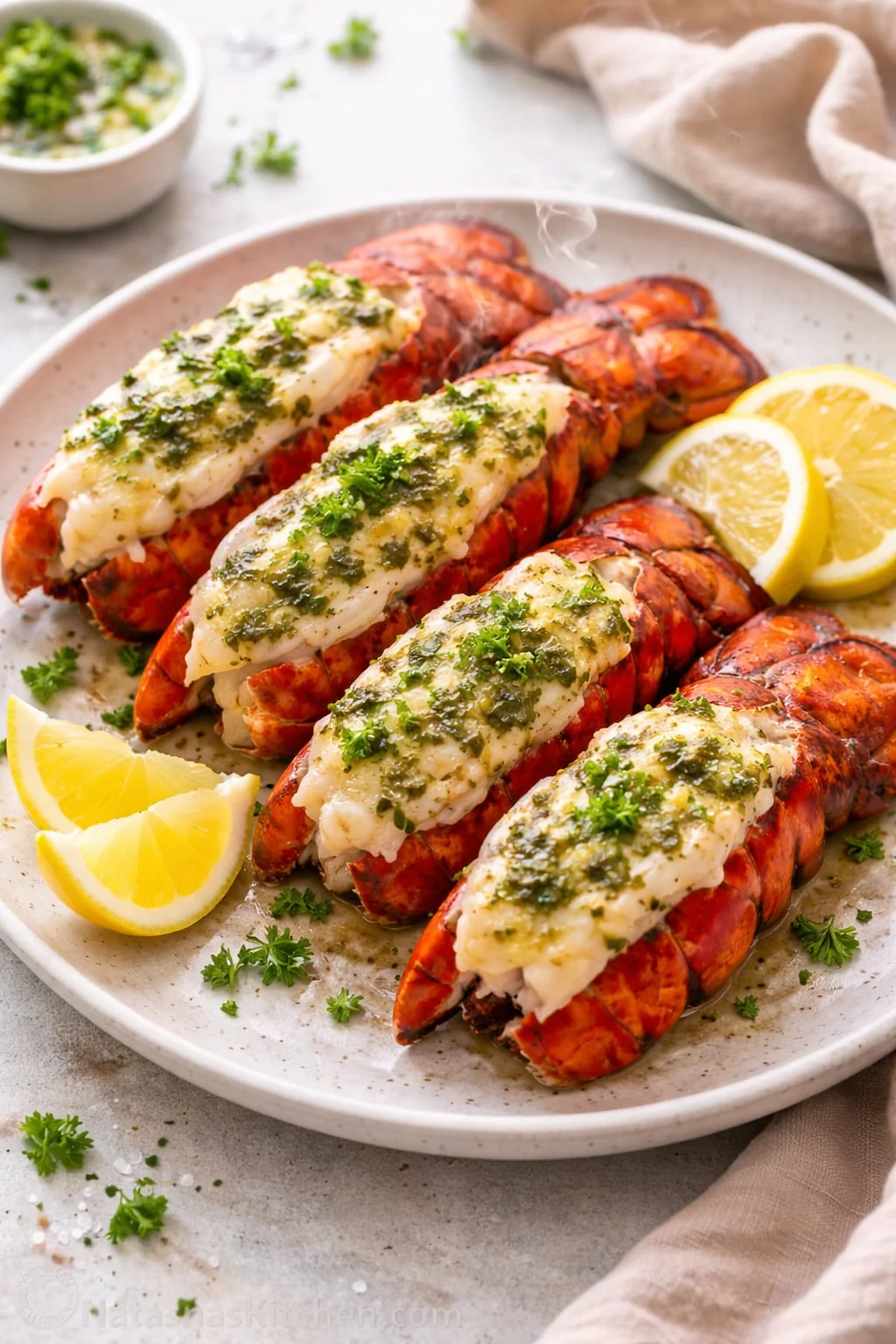 Delicious broiled lobster tails ready to serve with lemon and herbs