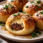 Garlic parmesan cheeseburger bombs freshly baked and served on a platter