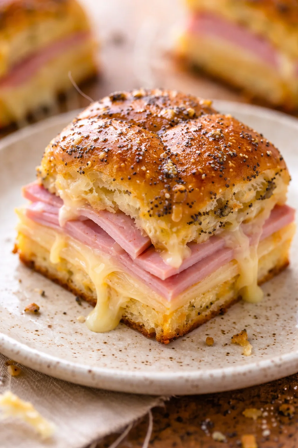 Savory ham and cheese sliders served on a platter, ideal for parties and gatherings