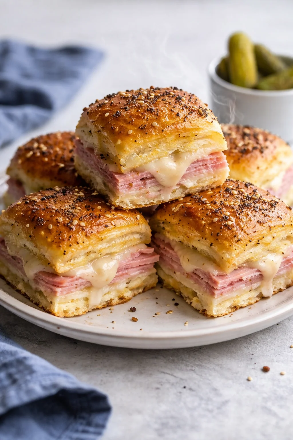 Ham and Swiss sliders with melted cheese on a platter