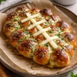 Cheesy stuffed garlic bread rolls topped with herbs and golden crust