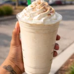 Cinnamon Roll Frappuccino topped with whipped cream and cinnamon.