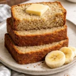 Loaf of easy moist banana bread with slices on a wooden cutting board