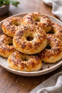 Freshly baked Greek yogurt bagels on a kitchen counter.