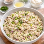 Healthy tuna salad in a bowl with fresh vegetables and dressing