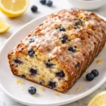 Sourdough Blueberry Lemon Quick Bread baked and sliced on a wooden board