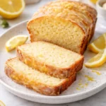 Sourdough discard lemon cake topped with fresh lemon zest and slices