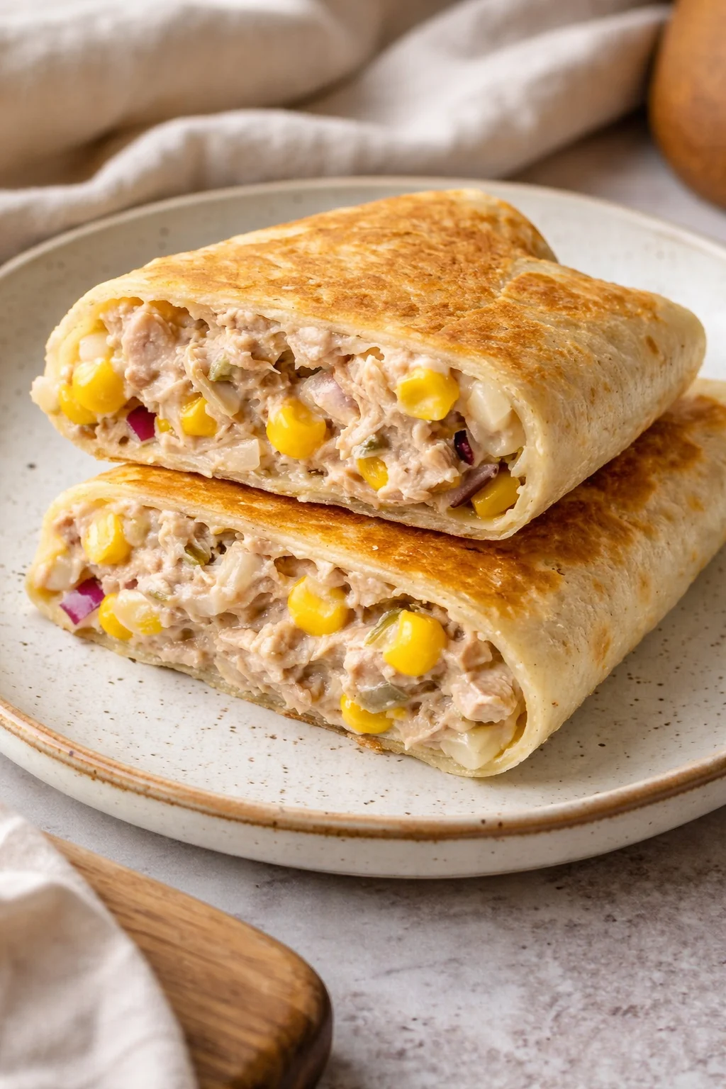 A delicious Tuna Melt Wrap filled with tuna, cheese, and fresh vegetables.