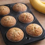 Delicious homemade banana muffins cooling on a wire rack.