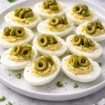 Dirty Martini Deviled Eggs appetizer with olives and garnish