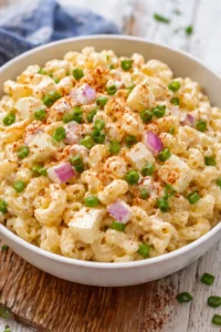 Flavorful deviled eggs pasta salad served in a bowl with garnishes