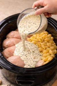 Slow Cooker Chicken and Shells dish served in a bowl with herbs
