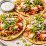 Buffalo Chicken Smash Tacos served on a plate with fresh toppings