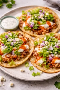 Buffalo Chicken Smash Tacos served on a plate with fresh toppings