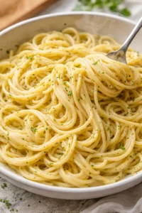 Creamy garlic butter pasta served on a plate with parsley garnish