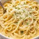 Creamy Garlic Parmesan Fettuccine served in a bowl with parsley garnish.