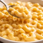 Bowl of extra creamy classic mac and cheese garnished with breadcrumbs.