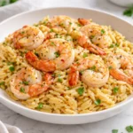 One-pot garlic butter shrimp orzo served in a bowl with fresh herbs