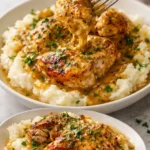 Slow Cooker Honey Mustard Chicken in a ceramic dish garnished with herbs.