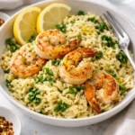 Plate of Zesty Lemon Garlic Shrimp Orzo garnished with herbs