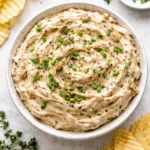 Brandied caramelized onion dip with a creamy texture served in a bowl