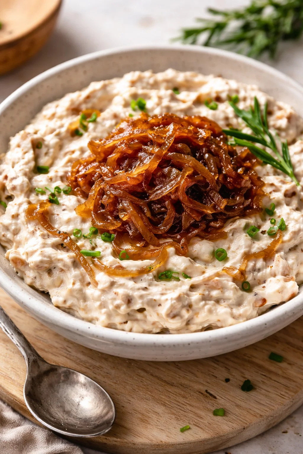 Delicious caramelized onion dip served in a bowl with tortilla chips
