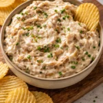 Creamy caramelized onion dip served with chips for appetizers