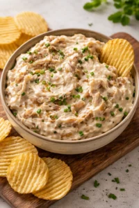 Creamy caramelized onion dip served with chips for appetizers